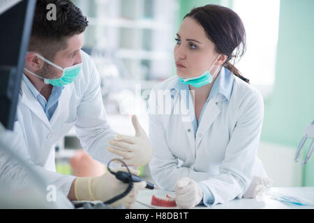 Dental students while working on the denture, false teeth. Stock Photo