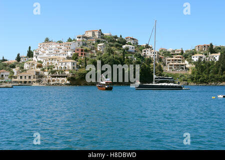 Sivota, GREECE, May 09, 2013: Landscape with green island,  buildings and yachts on the coast of Ionian sea, Greece. Stock Photo