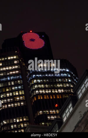 City of London, UK. 10th November 2016: An image of a poppy is displayed at the top of Tower 42 (NatWest Tower) on the evening before Remembrance Day. Credit:  CAMimage/Alamy Live News Stock Photo