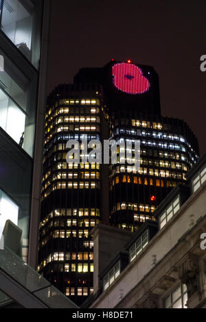 City of London, UK. 10th November 2016: An image of a poppy is displayed at the top of Tower 42 (NatWest Tower) on the evening before Remembrance Day. Credit:  CAMimage/Alamy Live News Stock Photo