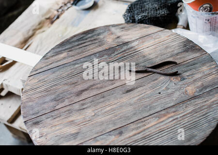 Old rusty steel pliers on wooden background Stock Photo