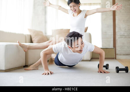 Young Chinese couple exercising at home Stock Photo