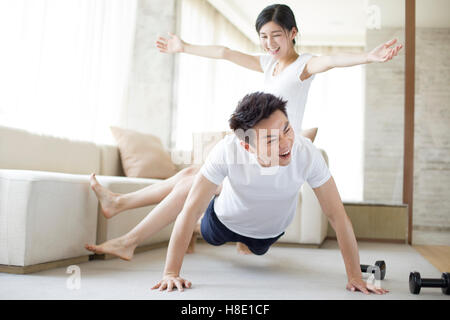 Young Chinese couple exercising at home Stock Photo