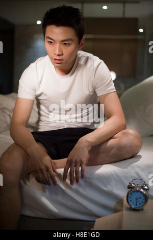 Young Chinese man suffering from insomnia Stock Photo