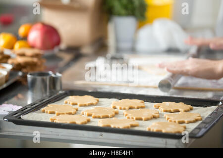Christmas gingerbread cookies in a row on tray Stock Photo