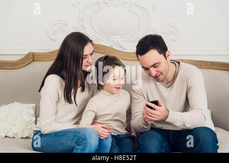 Family playing video game on smart phone Stock Photo
