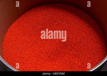 Colorful Red Pellets Used to Add Color To Plastic Stock Photo