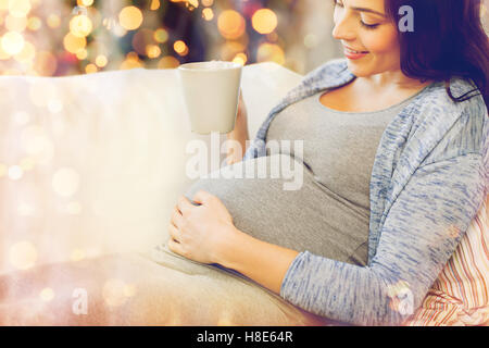 close up of pregnant woman drinking tea at home Stock Photo