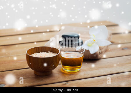 pink salt with honey, bath towel and hot stones Stock Photo