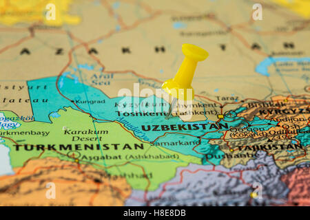 Map of  Uzbekistan with a yellow pushpin stuck Stock Photo