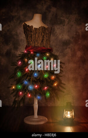 Vintage mannequin dressed for Christmas with old fashioned lamp Stock Photo