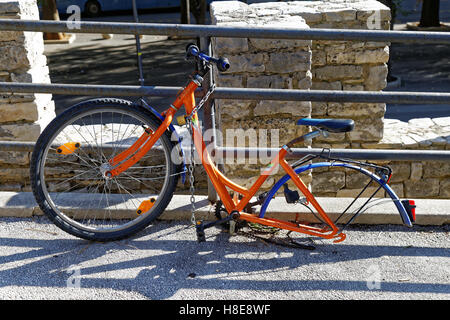 bicycle  abandoned on the street, dismounted one wheel Stock Photo