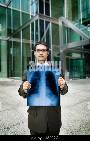 Businessman holding chest x-ray Stock Photo