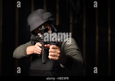 Military. A man with a gun wearing a bulletproof vest and helmet Stock Photo