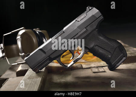 Glock pistol, cartridges and headphones protect ears Stock Photo