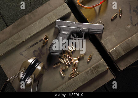 Glock pistol, cartridges and headphones protect ears Stock Photo