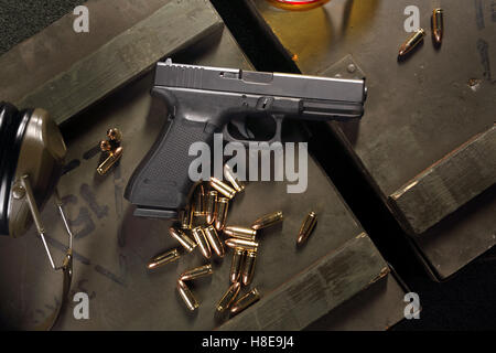 Glock pistol, cartridges and headphones protect ears Stock Photo