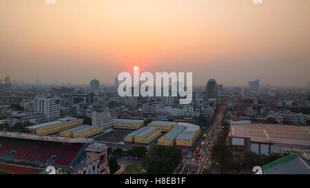 Sunset over polluted city air Stock Photo