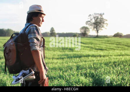man in nature with backpack and read book Stock Photo
