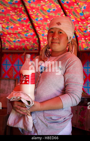 Kyrgyzstan - portrait of woman carrying bottle of  Kumis milk -  -  Travel people Central Asia - Silk Road Stock Photo