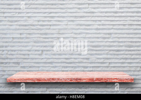 Empty top of pink granite stone table on white rough stone wall background. For product display Stock Photo