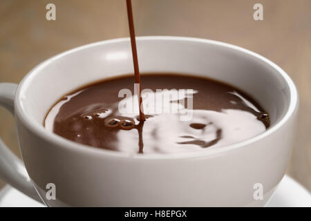 hot chocolate pouring in cup Stock Photo