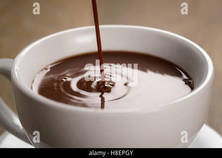 hot chocolate pouring in cup Stock Photo