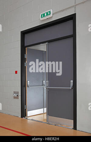 Fire escape door in the sports hall of a modern London school. Shows ...