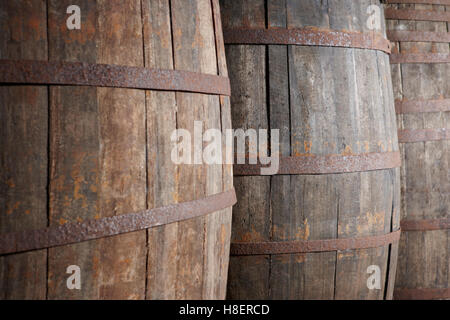 Old wine wooden barrels detail in a winery. Warm tone. Horizontal Stock Photo