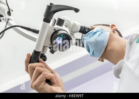 Using a dental microscope Stock Photo
