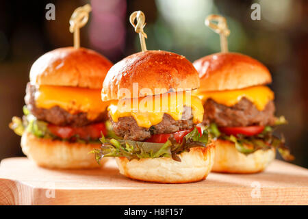 Close-up of home made burgers on wooden background Stock Photo