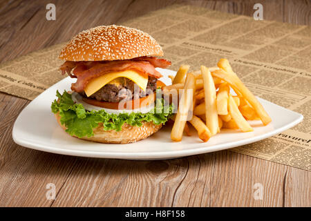 Burger with french fries on white plate Stock Photo