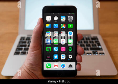 Detail of home page of large iPhone Plus smart phone with typical popular apps Stock Photo