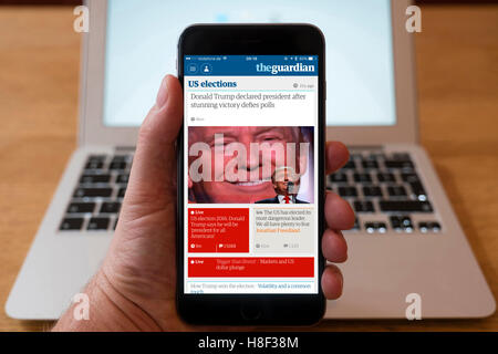 Detail of iPhone smart phone showing online mobile  newspaper front-page headline from The Guardian following Donald Trump's vic Stock Photo