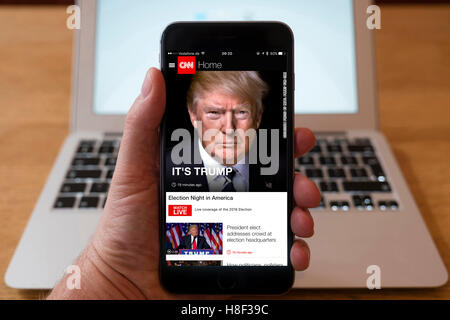 Detail of iPhone smart phone showing online mobile  newspaper front-page headline from CNN following Donald Trump's victory in 2 Stock Photo