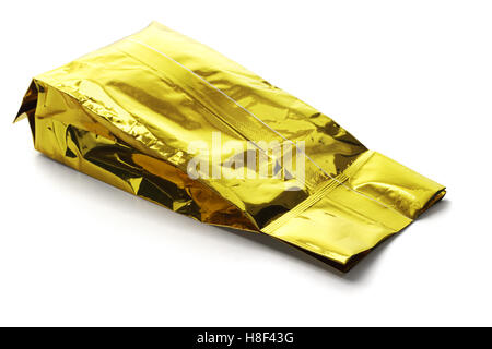 Golden Yellow Aluminum Pouch Lying on White Background Stock Photo