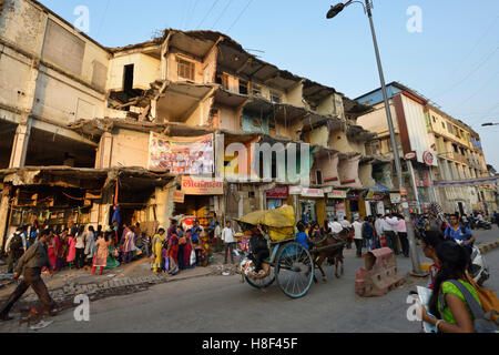 Abandoned Demolished Building Near Busy Market Street Stock Photo