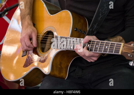Man plays acoustic guitar Stock Photo