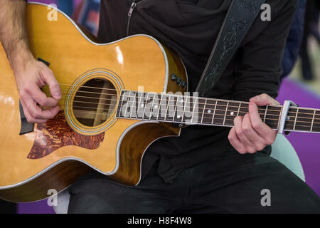 Man plays acoustic guitar Stock Photo