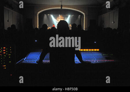 A sound engineer at his desk during a concert Stock Photo