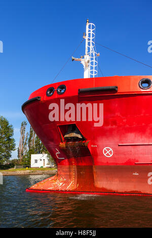 Old rusty anchor on the bow of a large cargo ship. Stock Photo