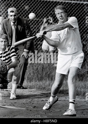 President Jimmy Carter at bat during a softball game at Plains High School in his hometown of Plains, Georgia. The umpire in the background is consumer advocate Ralph Nader and the catcher is  reporter James Wooten of The New York Times. Stock Photo