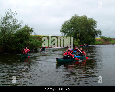 Group of young men canoeing on River Wye in Herefordshire England UK Stock Photo