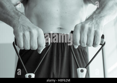 Performing exercises with resistance rope fitness Stock Photo