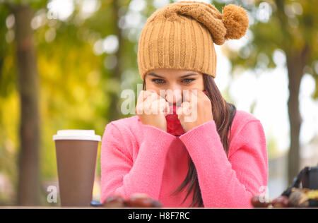 beautiful woman freezing in autumn park, cold autumn Stock Photo