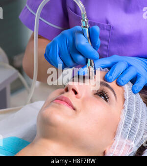 Image of Young beautiful woman gets skin treatment Stock Photo