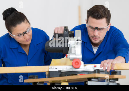 student in carpentry class using circular saw Stock Photo