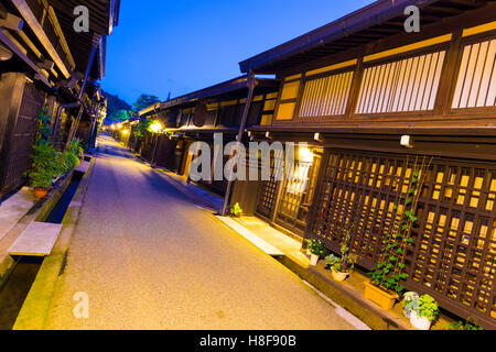 A row of traditional wooden houses line a street in old town neighborhood of Hida-Takayama, Gifu, Japan. Tilted wide angle persp Stock Photo