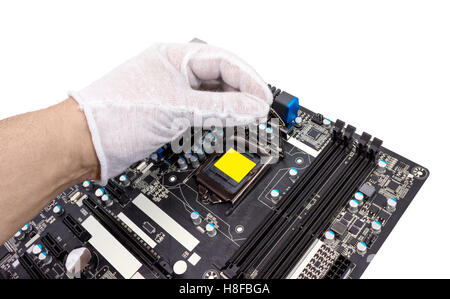Installation of modern processor in CPU socket on the motherboard Stock Photo