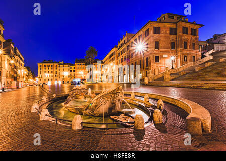 Spanish steps square and boat shaped fountain in Rome, Italy, at sunrise.Historic architecture of old palaces and houses. Stock Photo